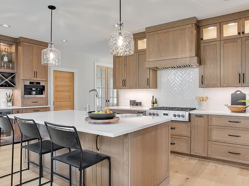 cherry cabinets with cherry wood kitchen range hood in this custom home in West Linn, Oregon