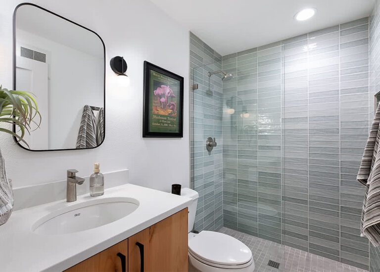 Hall bathroom remodel with Alder cabinets and black hardware.